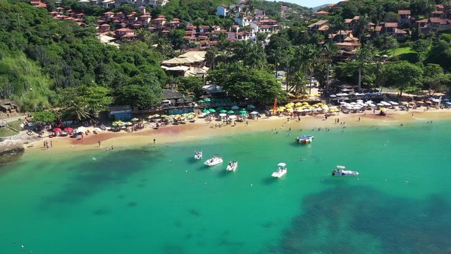 Arial shot over the colorful green waters of buzios bay in Brazil
