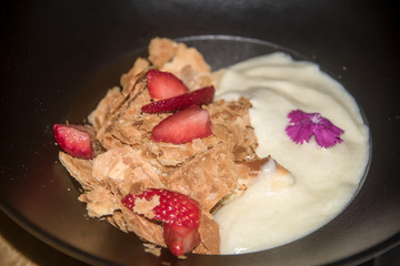 Beautiful dessert with ice cream, strawberries and puff pastry.
