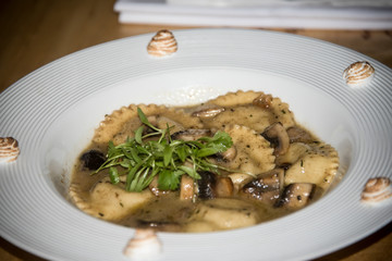 Ravioli and goat cheese, white wine oil and mushrooms.