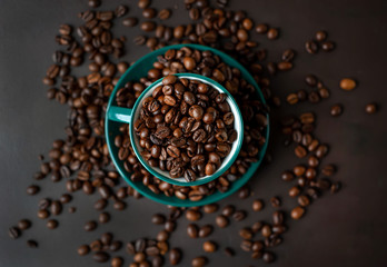 Coffee cup with coffee beans on a stone background