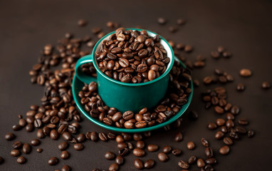 Coffee cup with coffee beans on a stone background