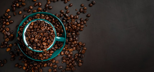 Coffee cup with coffee beans on a stone background
