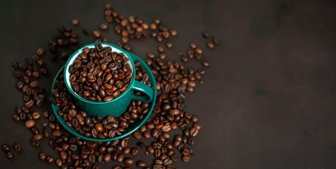 Coffee cup with coffee beans on a stone background