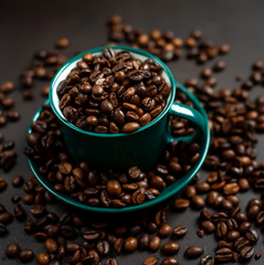 Coffee cup with coffee beans on a stone background