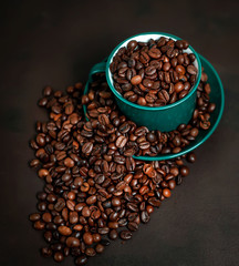Coffee cup with coffee beans on a stone background