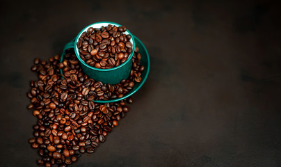 Coffee cup with coffee beans on a stone background