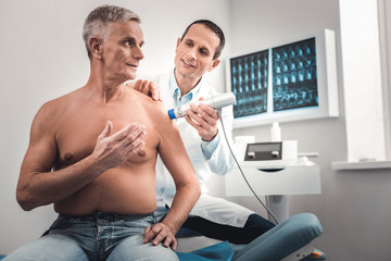 Elderly man coming to the hospital for checking his shoulder