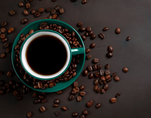 Obraz na płótnie Canvas Coffee cup with roasted beans on stone background