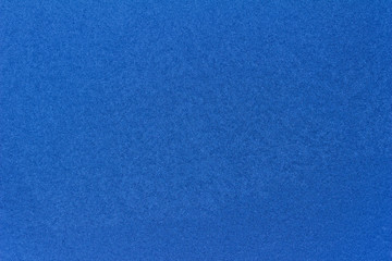 Macro view of ice or frost condensation on a window pane with a blue hue