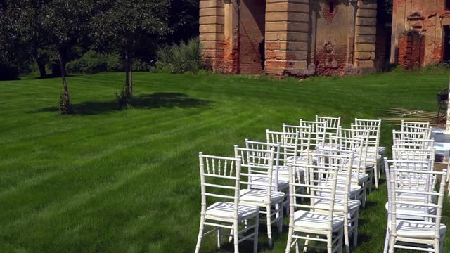 Chiavari chairs are displayed on the lawn in front of the church.