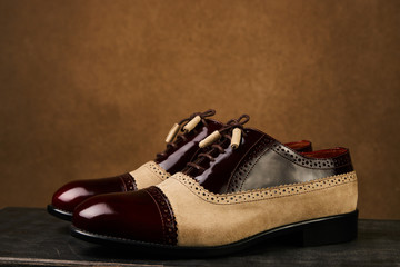 Groom's wedding shoes on a dark wooden box, close-up