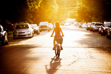 Young girl in a bike during sunset
