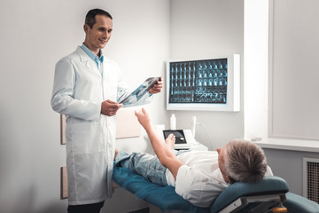 Patient lifting his hand for taking results of x-ray