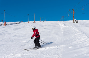 Woman downhill skiing in Lapland Finland