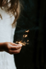 little girl holding sparkle firework