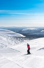 Fototapeta na wymiar Woman downhill skiing in Lapland Finland