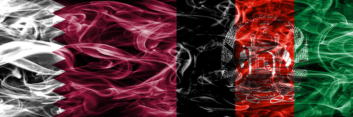 Obraz premium Qatar vs Afghanistan, Afghani smoke flags placed side by side. United Arab Emirates. UAE.