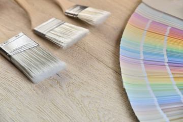 Paint brush and palette color on wood background