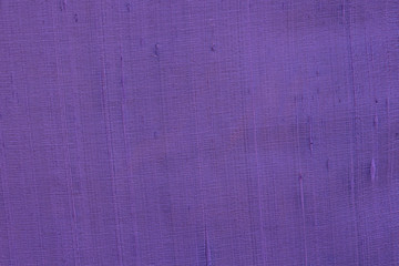 Close up of a woolen fabric of violet blue color. Abstract canvas background, empty template.