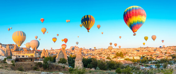 Colorful hot air balloons flying over at fairy chimneys in Nevsehir, Goreme, Cappadocia Turkey. Hot air balloon flight at spectacular Cappadocia Turkey.   © Hakan Tanak