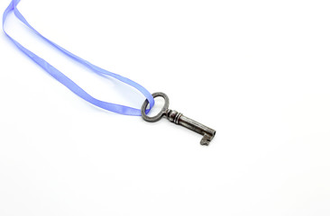 Vintage silver key on blue ribbon on white background