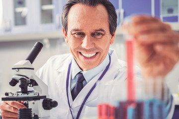 Physician feeling satisfied using new microscope