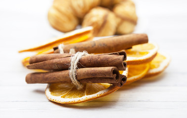Orange slices with cinnamon in the background cookies on a light wooden table, cooking concept