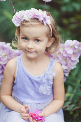 girl sniffing flowers of azaleas. flowering azaleas in the park