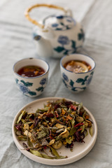 Fototapeta na wymiar Spring detox concept. Herbal tea in a ceramic tableware and tea cups