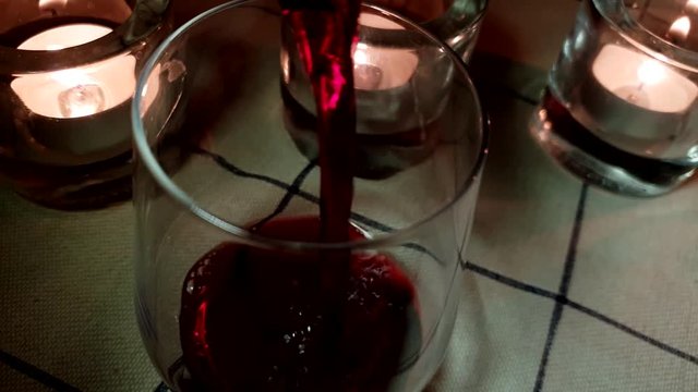 red wine poured into cozy glasses, improvised casual friday vibe with round bottom glass and ordinary everyday tablecloth, cinematic slider