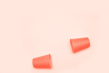 Plastic cups on living coral background.
