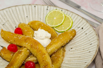 Baked caramelized bananas. Homemade sauteed bananas foster. Typical cuban dish - fried sliced banana. Ripe fried plantain - traditional dish in Central America 
