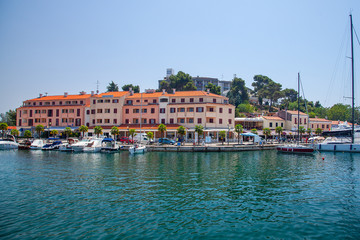 Fototapeta na wymiar View from the sea on the old historic town of Porec, Croatia.