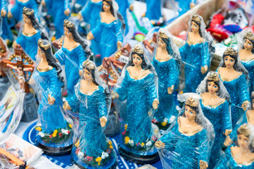 Handmade craft souvenir figurines of the Yoruba goddess Yemanja stand on display at the annual festival dedicated to her in Salvador, Bahia, Brazil