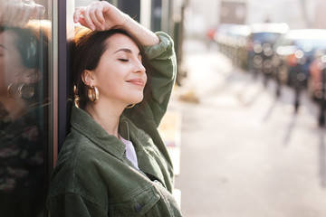 Pretty girl sit outside office smile to camera and feeling good