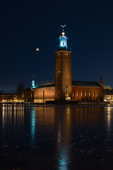 Fototapeta na wymiar stockholm city hall at night with blood moon in the sky