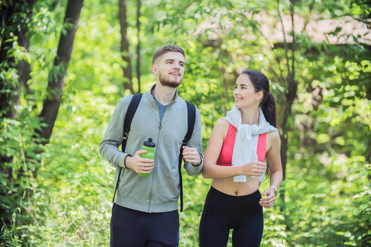 young couple of runners at Forest Environments, wandering in forests