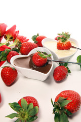 Valentine Chocolate fondue melted with fresh strawberries and dark and white chocolate. Tublips and sugar hearts.