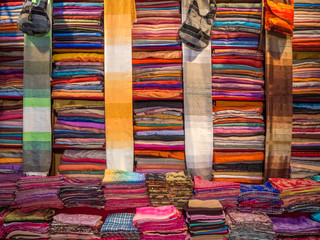 Inside interior of Carpet shop with colourful moroccan rugs and berber carpets on display in a souk market in the centre of medina. Fes El Bali (Maze of Fez)