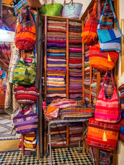 Inside interior of Carpet shop with colourful moroccan rugs and berber carpets on display in a souk market in the centre of medina. Fes El Bali (Maze of Fez)