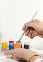 the artist paints a picture with color paints