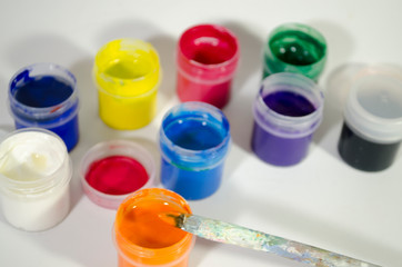 the artist paints a picture with color paints