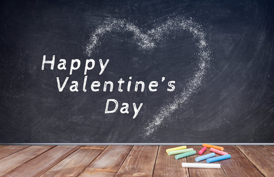 happy valentine's day writing on chalkboard with chalk