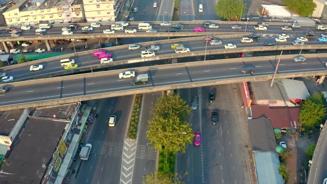 Top view of elevated expressway. Beautiful aerial shot of the curve of suspension bridge in daytime in Bangok, Thailand. Scenic road, big city life and transportation concept.