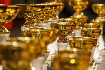 Gold metal cups to athletes stand on a pedestal