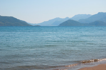 Scenic view of the Aegean sea and Rocky mountains at Marmaris resort. Mountains in the haze.
