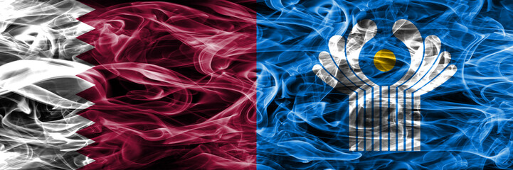Obraz premium Qatar vs Commonwealth smoke flags placed side by side. United Arab Emirates. UAE.