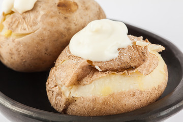 Traditional Colombian cooked potatoes called papas saladas topped with mayonnaise isolated on white background