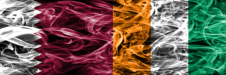 Qatar vs Ivory Coast smoke flags placed side by side. United Arab Emirates. UAE.