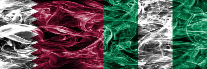 Obraz premium Qatar vs Nigeria, Nigerian smoke flags placed side by side. United Arab Emirates. UAE.
